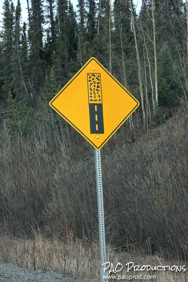 Gravel roadway sign along the Alaska Highway