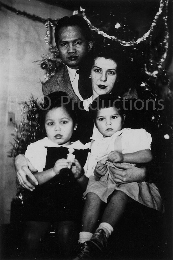 Interracial family at Christmas, circa 1940s