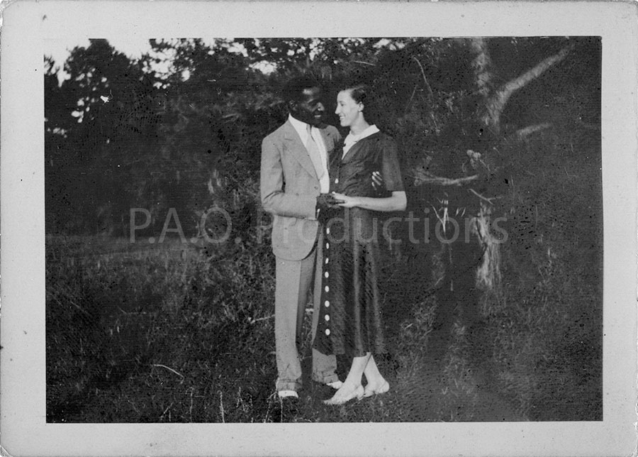 Interracial couple in bucolic setting, likely 1950s