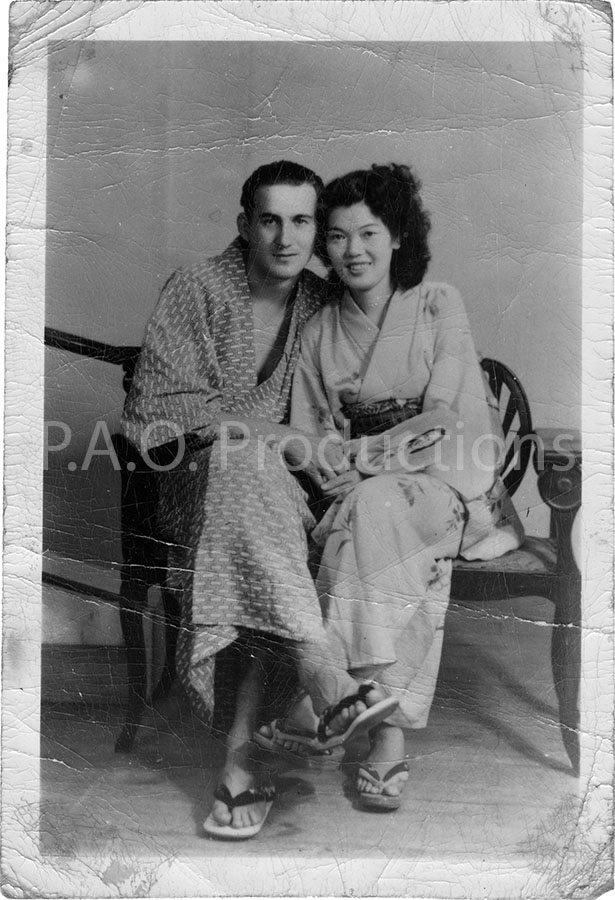 Affectionate interracial couple in kimonos and zoris